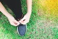 Tying sport shoes on yard, Asian woman getting ready for running, Outdoor sport, Exercise, Fitness training. Healthy lifestyle Royalty Free Stock Photo