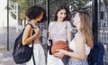 Tylish cool teen girls gathering at basketball court, friends ready for playing basketball outdoors