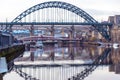 Tyne Bridge mirrored in the River Tyne, Newcastle, UK with Swing, Queen Elizabeth II and High Level bridges in the background Royalty Free Stock Photo