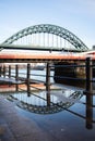 Tyne Bridge on Newcastle Quayside with reflection in puddle after rainstorm Royalty Free Stock Photo