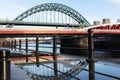 Tyne Bridge on Newcastle Quayside with reflection in puddle after rainstorm Royalty Free Stock Photo