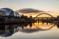 The Tyne Bridge at sunset, reflecting in the almost still River Tyne beneath