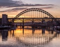 The Tyne Bridge at sunset, reflecting in the almost still River Tyne beneath Royalty Free Stock Photo