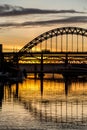 The Tyne Bridge at sunset, reflecting in the almost still River Tyne beneath Royalty Free Stock Photo