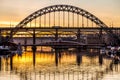 The Tyne Bridge at sunset, reflecting in the almost still River Tyne beneath Royalty Free Stock Photo