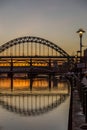 The Tyne Bridge at sunset, reflecting in the almost still River Tyne beneath Royalty Free Stock Photo