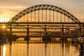 The Tyne Bridge at sunset, reflecting in the almost still River Tyne beneath Royalty Free Stock Photo