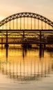 The Tyne Bridge at sunset, reflecting in the almost still River Tyne beneath Royalty Free Stock Photo