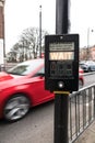 Lluminated Wait sign at pedestrian crossing with red car speeding past on road Royalty Free Stock Photo