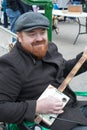 Tynemouth Metro Station Weekend Flea Market. Man plaing stringed guitar style instrument to entertain shoppers