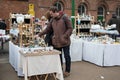 Tynemouth Metro Station Weekend Flea Market. Stall selling vintage items with customers persuing