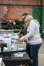 Tynemouth Metro Station Weekend Flea Market. Stall selling vintage vinyl records with customers browsing