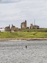 Tynemouth Priory and coast guard station with paddle boarder