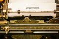 Type writer and paper, word authenticity