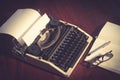 Typewriter with book,eyeglasses and pen