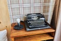 The typewriter is on the old table