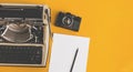 Typewriter, Retro Film Camera, Sheet Of Paper And Pencil On Yellow Background Royalty Free Stock Photo