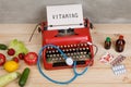 typewriter and text Vitamins - choice between natural vitamins, vegetables, fruits and berries or tablets