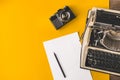Typewriter, Vintage Film Camera, Sheet Of Paper And Pencil On A Yellow Background, Top View. Creative writing concept Royalty Free Stock Photo