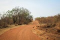 A typical African road in the countryside is dry red earth Royalty Free Stock Photo