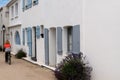 Typical alley in the center of Noirmoutier island with woman biker tourist