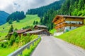 Typical alpine building oon green meadow, Austria