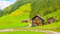 Typical alpine buildingm green meadows in Austria