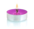 Typical aluminium burning purple tealight candle isolated on white background with shadow reflection.