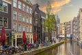 Typical Amsterdam houses and cafes along the canal, sunset view from Bet Van Beerenbrug bridge, dutch lifestyle Netherlands Royalty Free Stock Photo