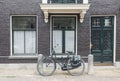 Typical Amsterdam street view in Netherlands with old doors and windows and vintage bicycle