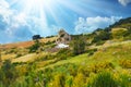 Typical andalusian calm mountain valley landscape, sun rays, low morning clouds, idyllic white farm house in rock front, Royalty Free Stock Photo