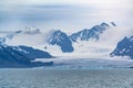 Typical antarctic landscape with high mountains and glacier reaching to the sea, South Georgia Foggy weather