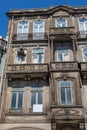 Typical Antique Portuguese Architecture: Grey Facade with Old Wi