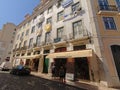 Typical apartment building in with shops on street level in Lisbon, Portugal