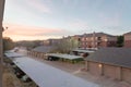 Typical apartment complex with detached garage and covered parking lots at sunrise