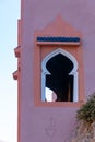 Typical arabesque window on facade in a construction of Morocco