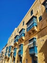 Typical architectural details of the old town. Icicles on the roof of the old house. A closeup of buildings with a blue sky Royalty Free Stock Photo