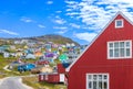 Typical architecture of Greenland city Qarqotoq with colored houses located near fjords and icebergs Royalty Free Stock Photo