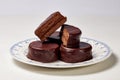 Typical Argentine Alfajor of dark chocolate cut in the middle where you can see the interior of chocolate and the filling of dulce Royalty Free Stock Photo