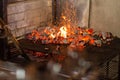 Typical Argentinian barbecue or asado. Burning wood in the grill and red hot coals Royalty Free Stock Photo