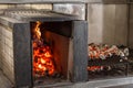 Typical Argentinian barbecue or asado. Burning wood in the grill and red hot coals Royalty Free Stock Photo