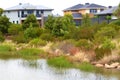 Typical Australian plants take center stage against the backdrop of charming two-story houses