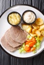 Typical Austrian Tafelspitz cooked with beef, fresh vegetables, aromatic seasoning served with potatoes, horseradish and apple