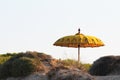 Typical Balinese sun umbrella standing on the beach. Salento, Italy