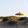 Typical Balinese sun umbrella standing on the beach. Salento, Italy