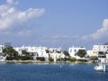 typical beach community with Cyclades style white house blue door Pollonia Milos Greece