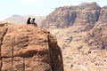 Typical Bedouins sitting on rock at High place of sacrifice in ancient city of Petra, Jordan Royalty Free Stock Photo