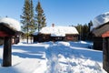 Typical black Norwegian cabin with path made in deep snow