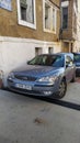 Typical blue sedan parked in a town, a third-generation Ford Mondeo
