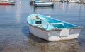 Typical boat above the crystal clear water. The non motorized sea vehicle docks in the shallow area of the seaside. Fishing machin Royalty Free Stock Photo